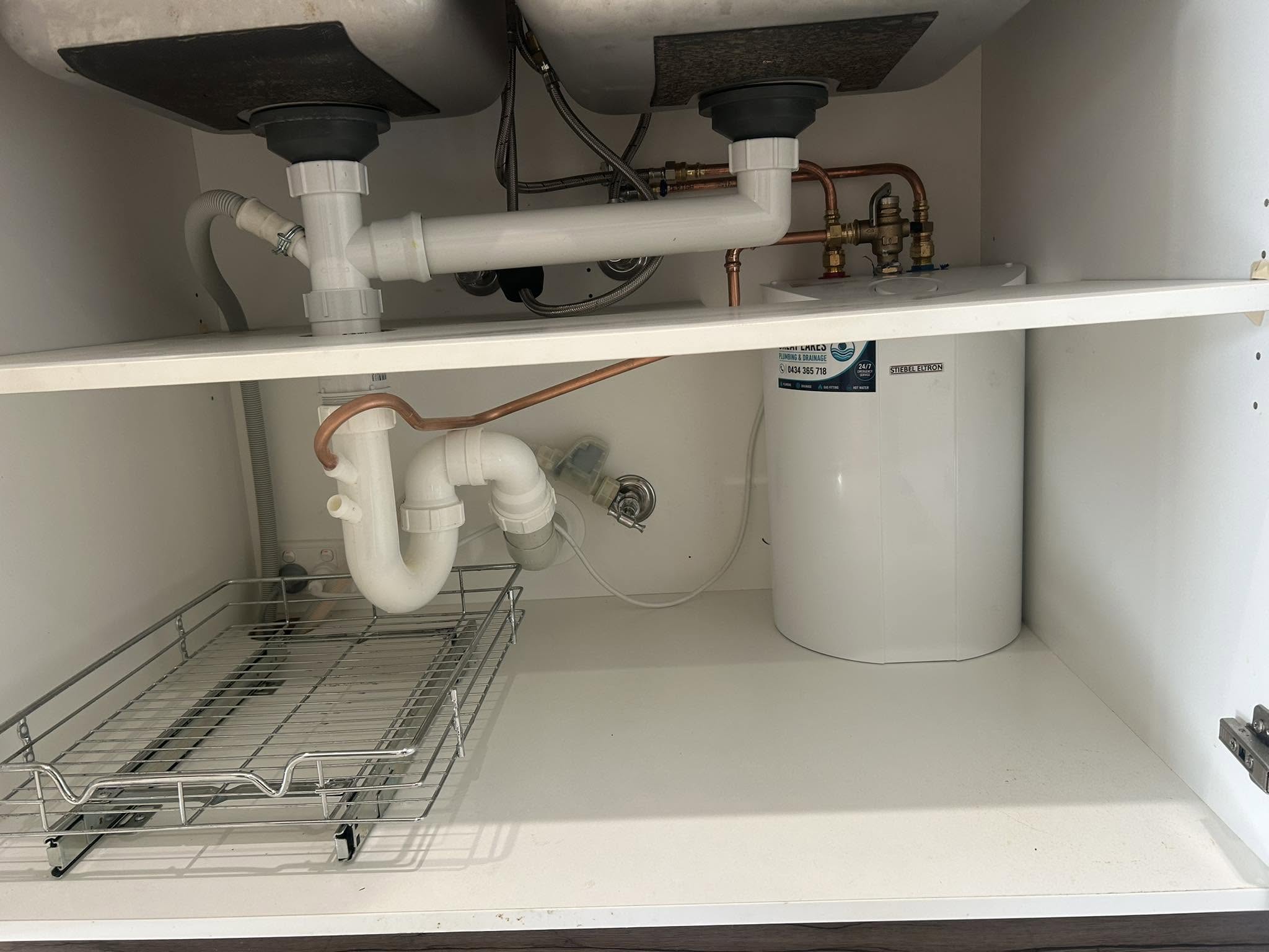 New waste pipework and connections installed under a sink