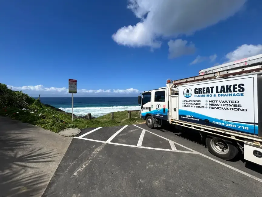 Great Lakes Plumbing & Drainage service truck parked beside the coast