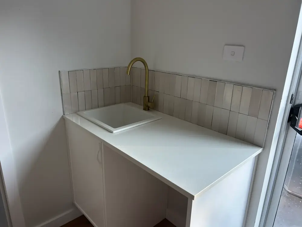 New laundry sink and benchtop with a brass tap