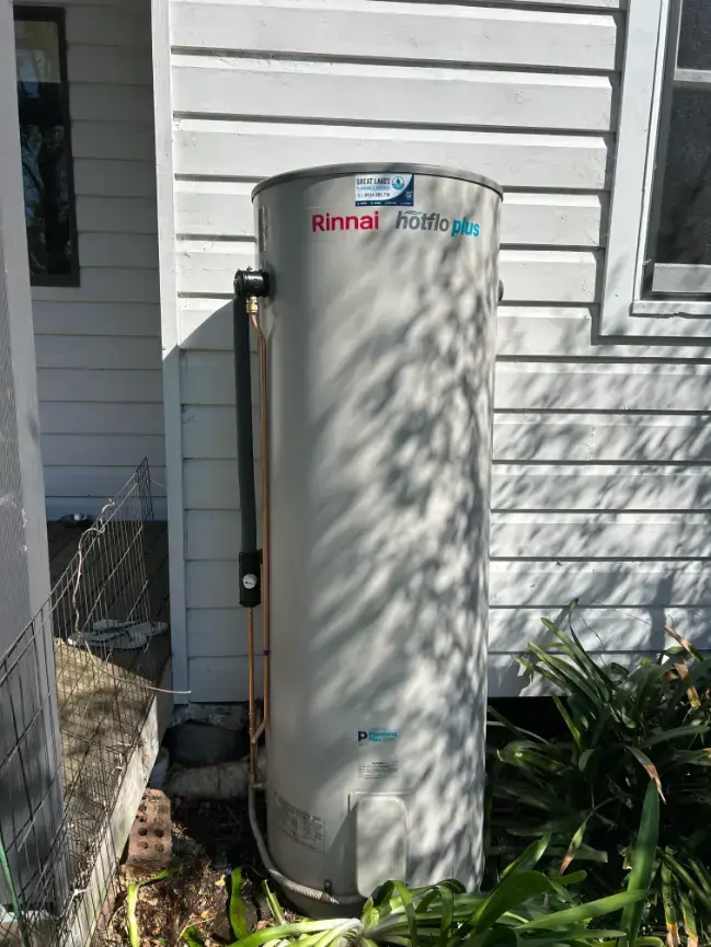 Rinnai hot water cylinder installed outside beside weatherboard cladding