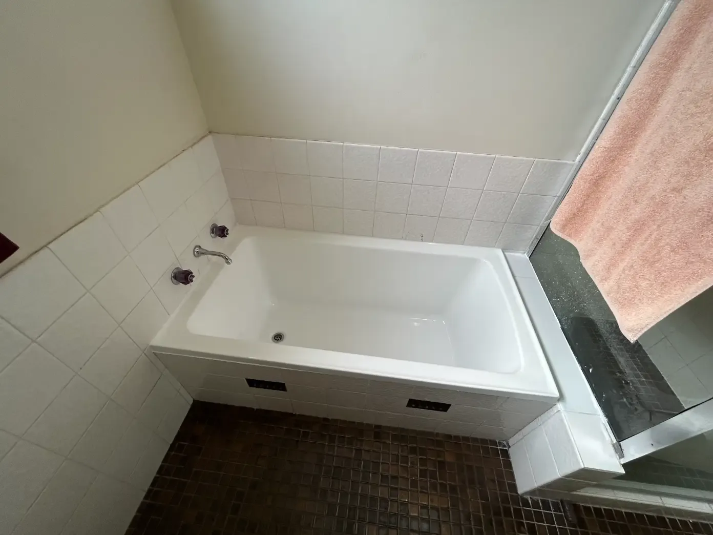 White bathtub installed in a tiled bathroom