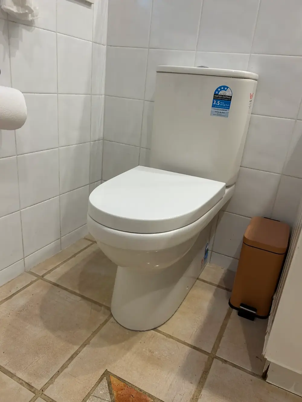 White toilet installed in a tiled bathroom